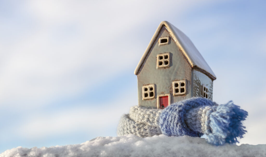 Clay Model of a Home Wrapped in a Scarf as a Metaphor for Winter Proofing Your Rental Property in San Antonio TX