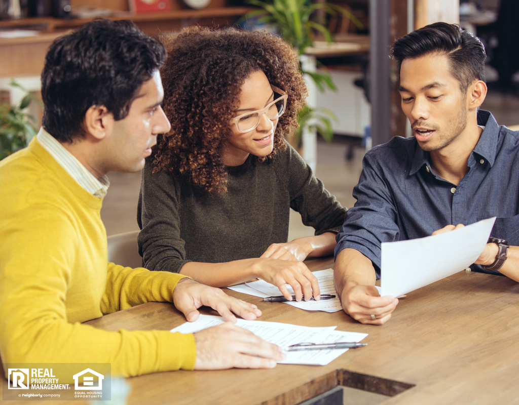 Property Owner and Tenants Discussing Terms During A Lease Signing