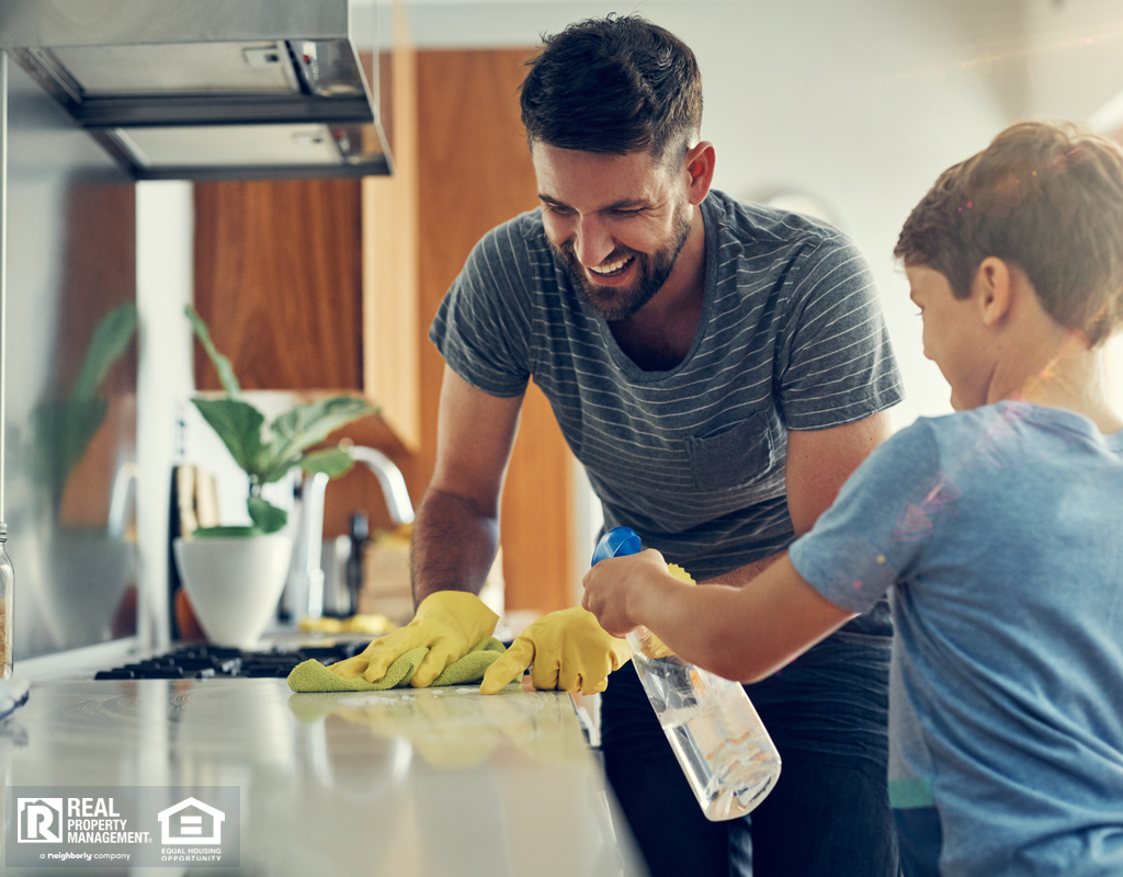 Father and Son Cleaning Kitchen Together