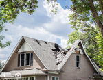 Close up image of a roof of a house that has burned and fallen in.