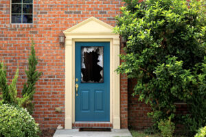Close up shot of broken door window glass of brick house 