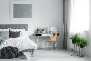 Pristine Bedroom with A Pair of Ferns by the Window