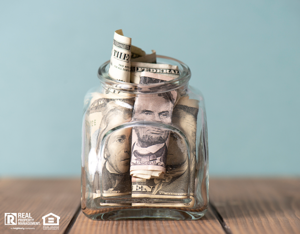 Mason Jar with Several Dollar Bills Stuffed Inside as an Emergency Fund