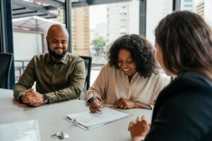 Couple finalizing rental contract with a property manager.