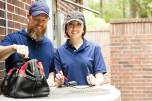 HVAC Professionals Inspecting AC Equipment