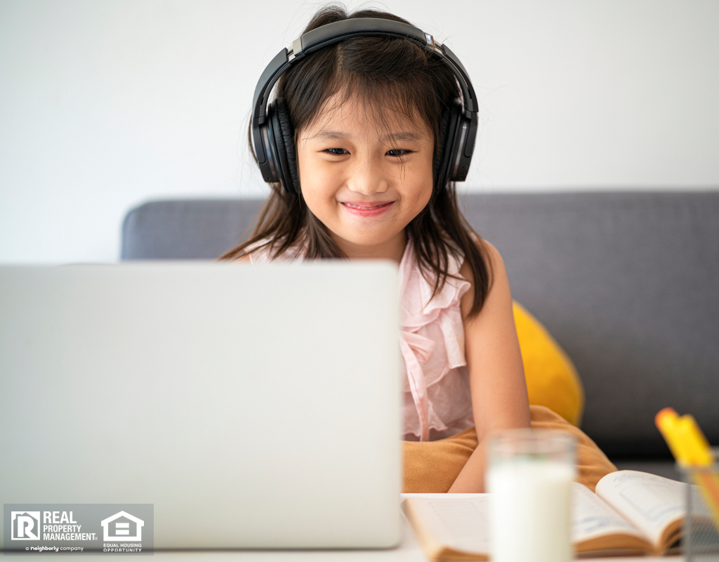 Child Learning Online with Black Headphones On