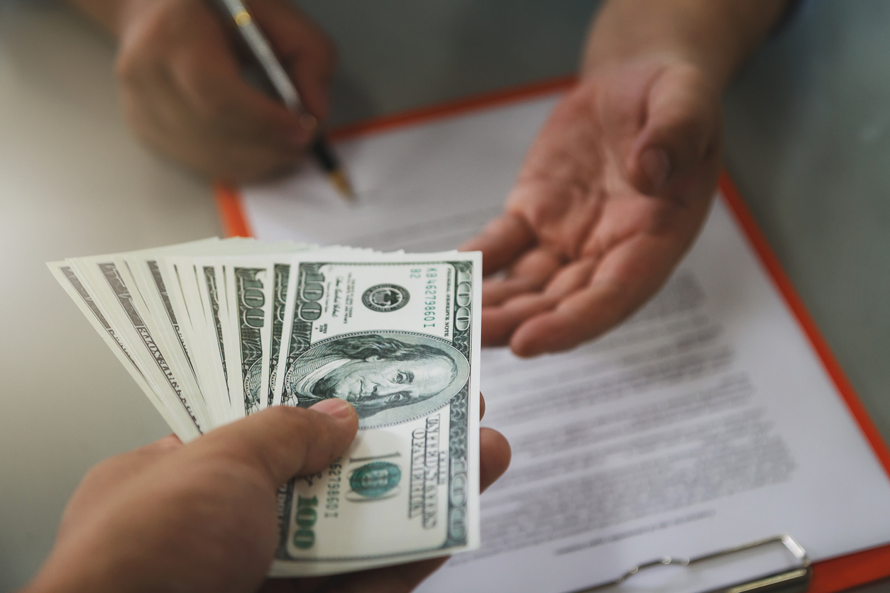 man paying rent in cash