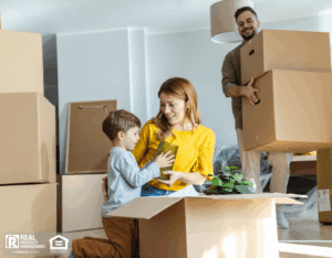 A family joyfully moving into their new home, surrounded by boxes and packing materials.