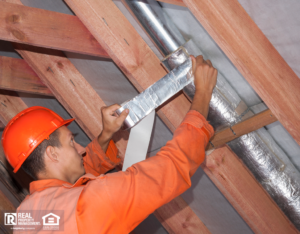 Man Wrapping Pipes in a Tucker Rental Property