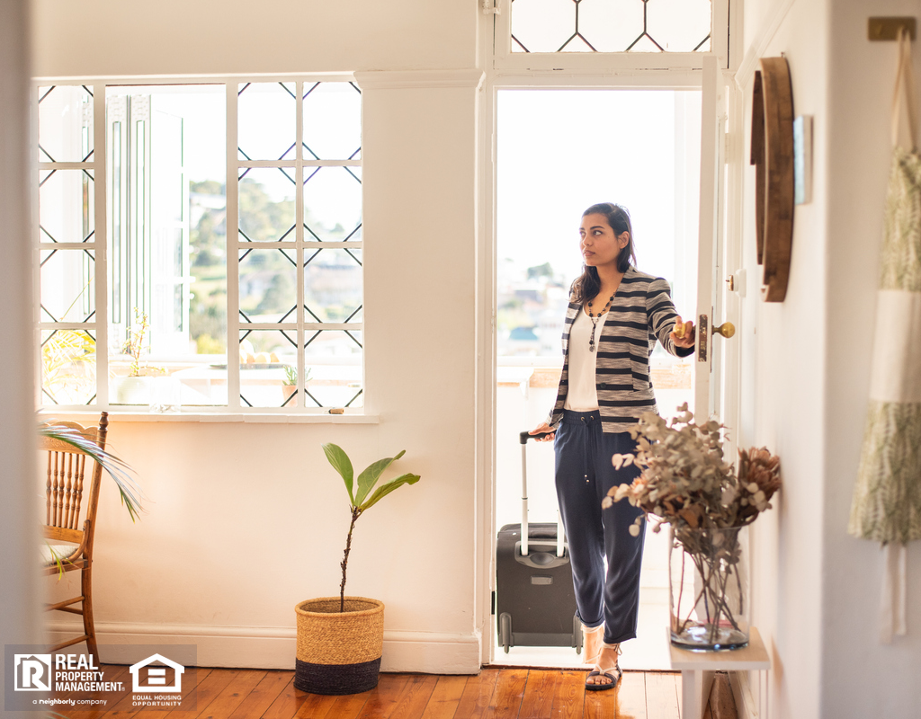 Woman Walking Into a North Charleston Short-Term Rental with a Suitcase