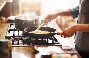 Cropped shot of a woman preparing a meal at home.