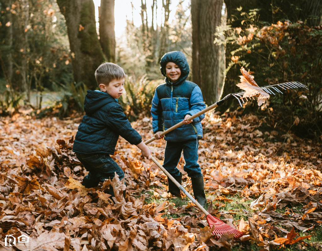 A Pair of Boys Raking Up the Autumn Leaves in Prairieville