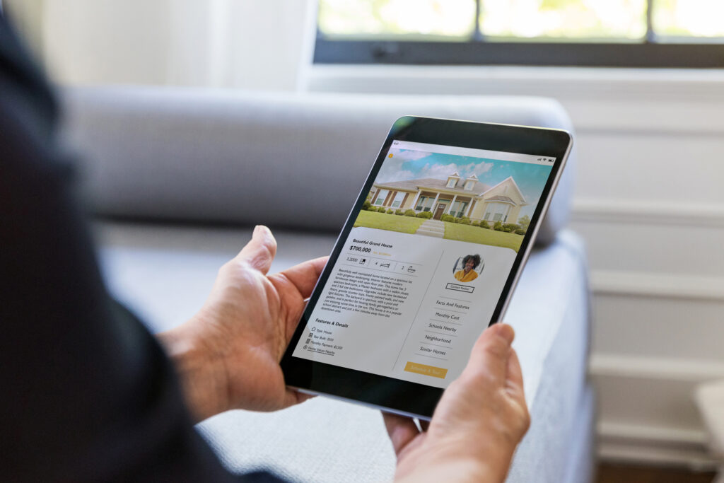 using a real estate app to look at houses on the market