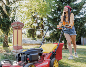 A woman performs summer maintenance by mowing her lawn.