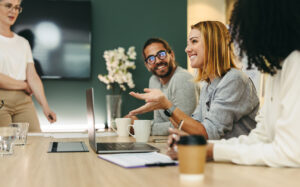 group talking about work in front of a laptop