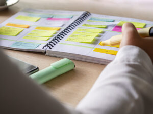 sticky notes on an agenda to keep organized. person is highlighting