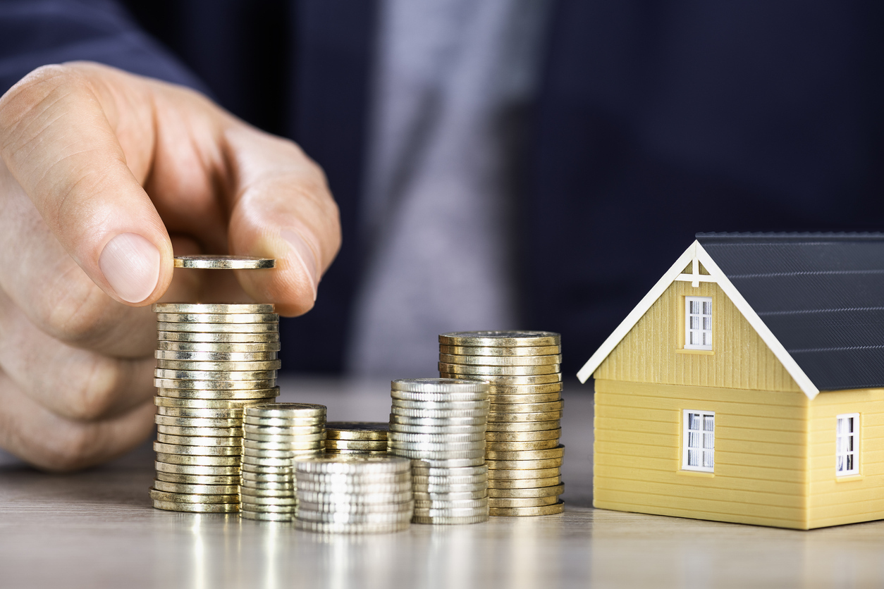 Model House with Stacks of Coins