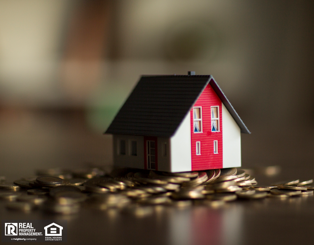 Miniature House on a Pile of Coins