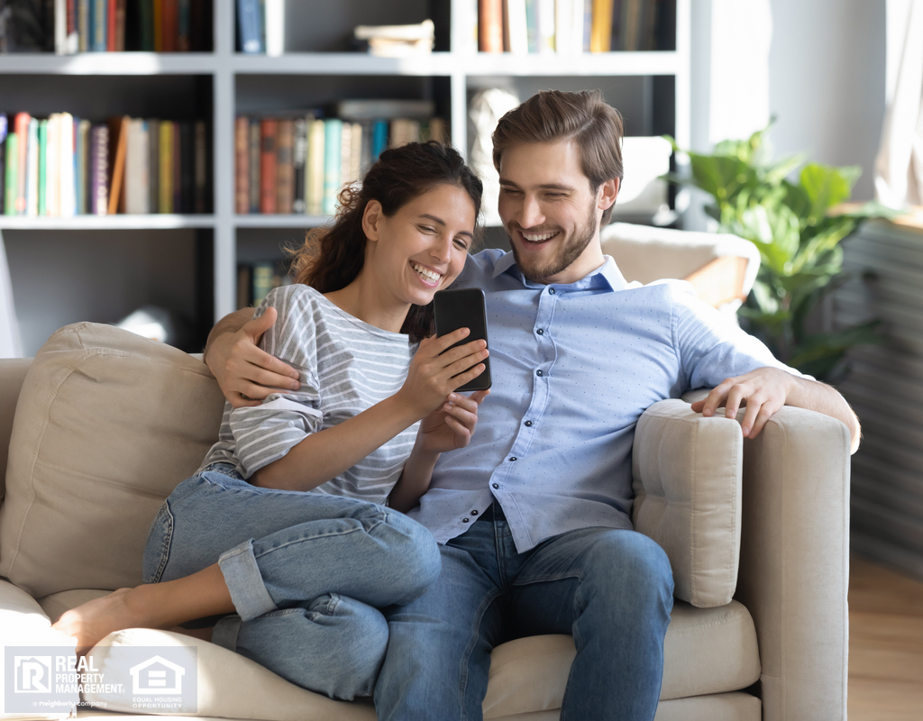 Couple in Chester Apartment Smiling at a Smartphone