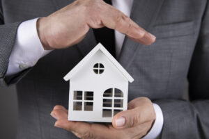Business Man Protecting a Vacant Home Model