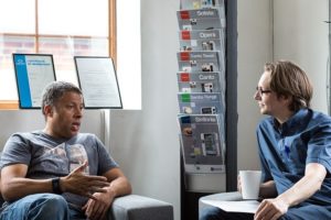 Tenant and landlord sitting and chatting over coffee