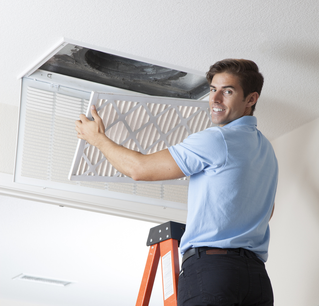 Maintenance Man Installing a Fresh Air Filter in the HVAC System Real
