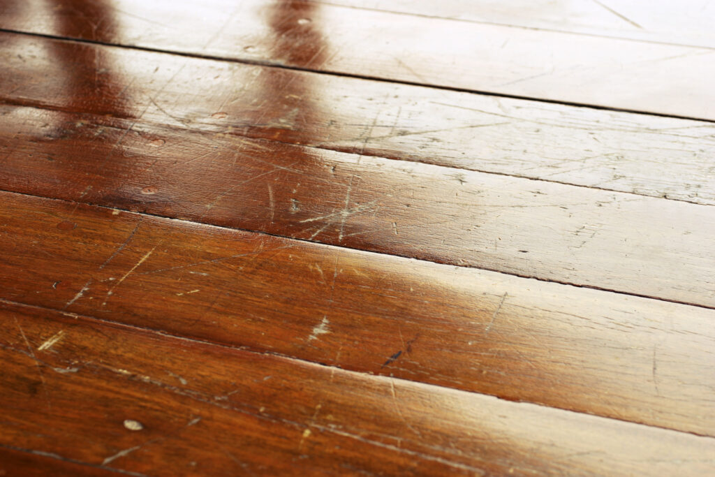 Close-up of a grungy wooden floor.