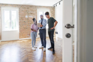 Real estate agent showing apartment for sale to a couple