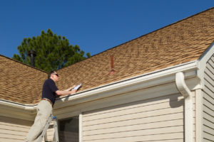 Home inspector examines a residential roof vent pipe