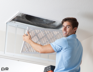 Maintenance Man Installing a Fresh Air Filter in the HVAC System