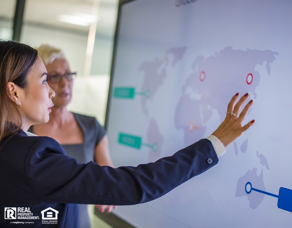 Levittown Real Estate Investors Looking at International Properties on a Large Screen