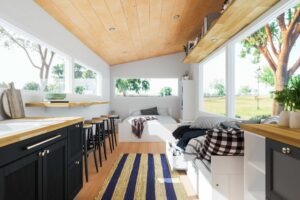 Tiny home kitchen with a sink, stove, and counter, designed for functionality in a small living space.