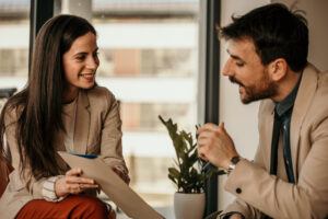 Cheerful property manager meeting with a tenant in a modern workplace