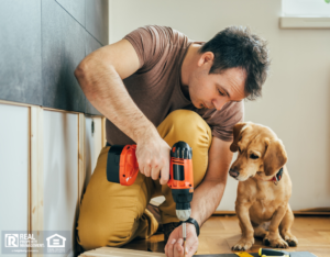 Batesville Tenant Using a Drill With His Dog Watching