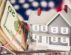 Model House and Cash in a Miniature Shopping Cart