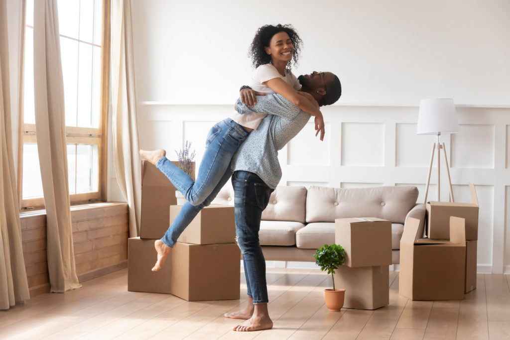 Happy couple moving into their new rental home