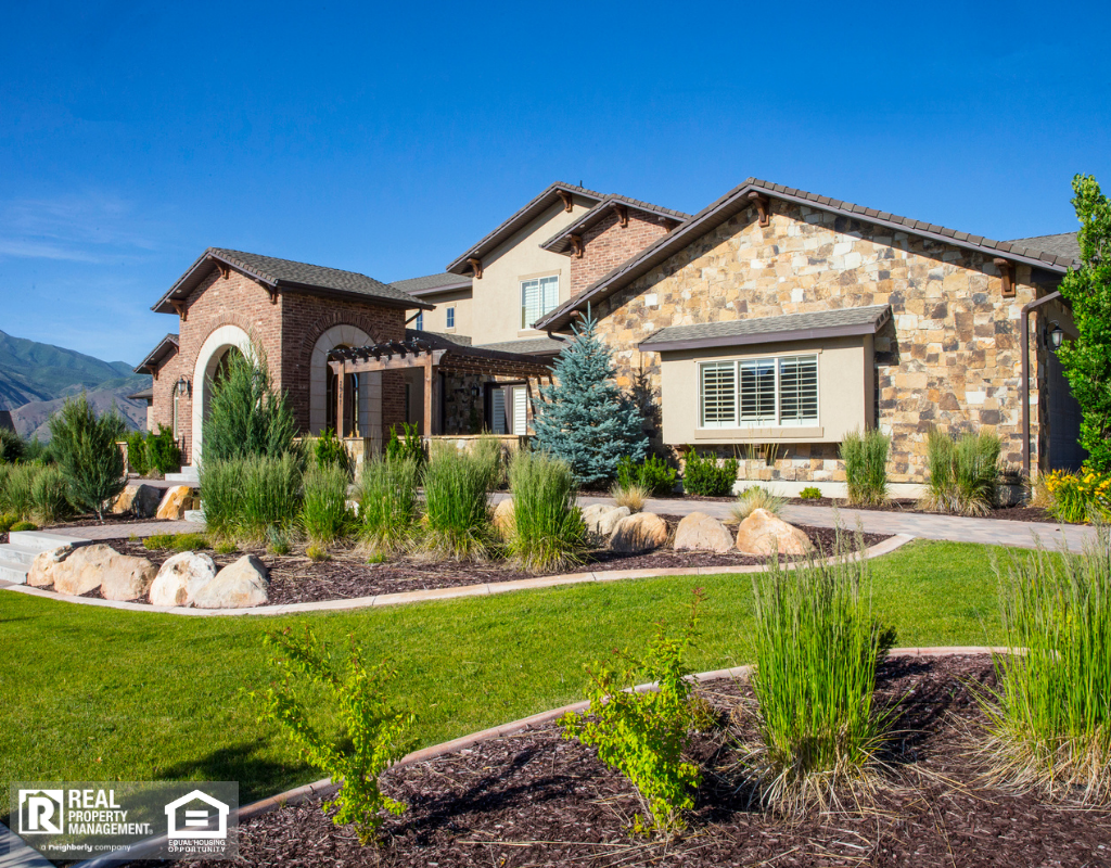 View of property and landscape with green grass and house.