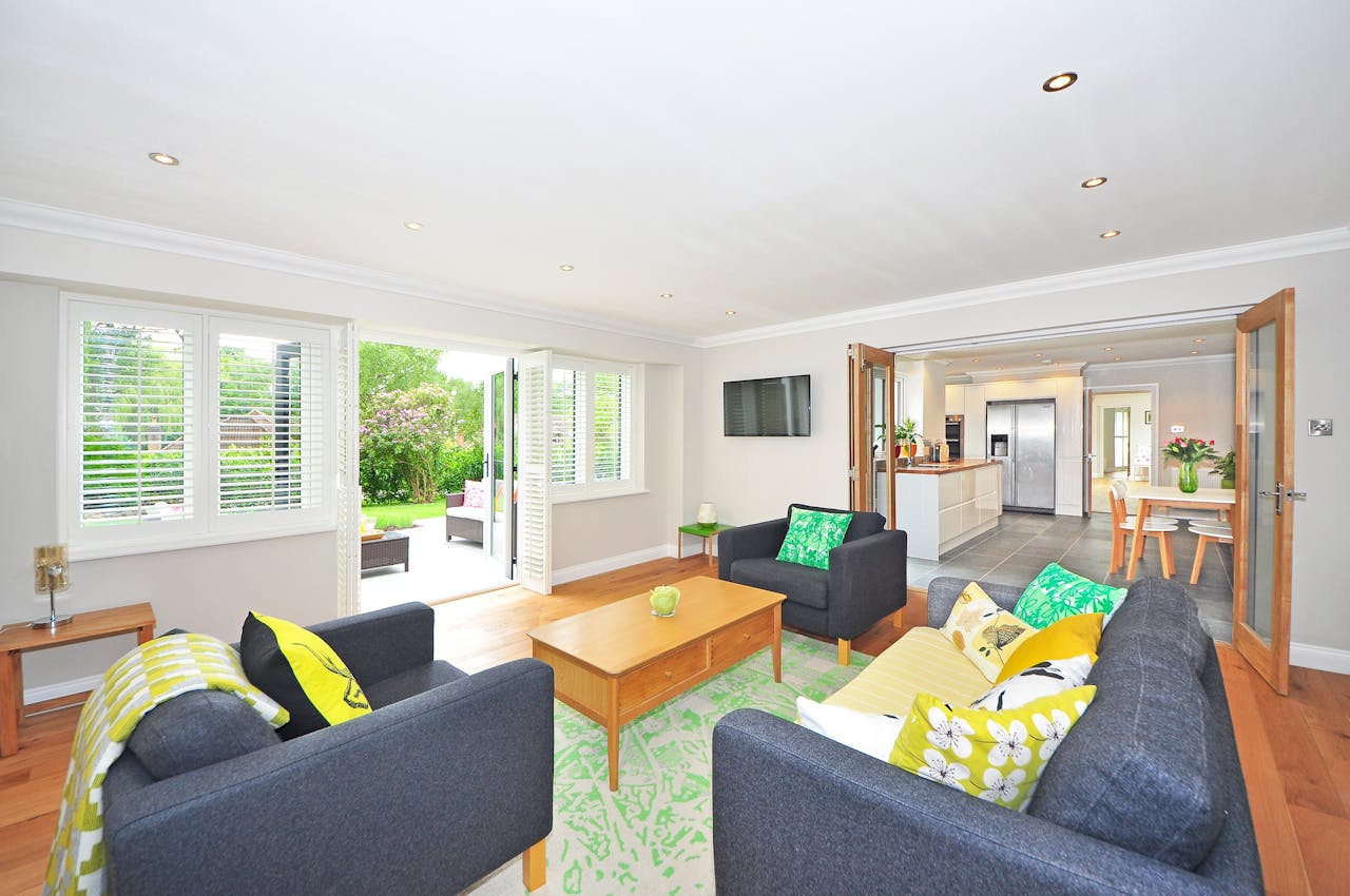 living room with green rug and open doors