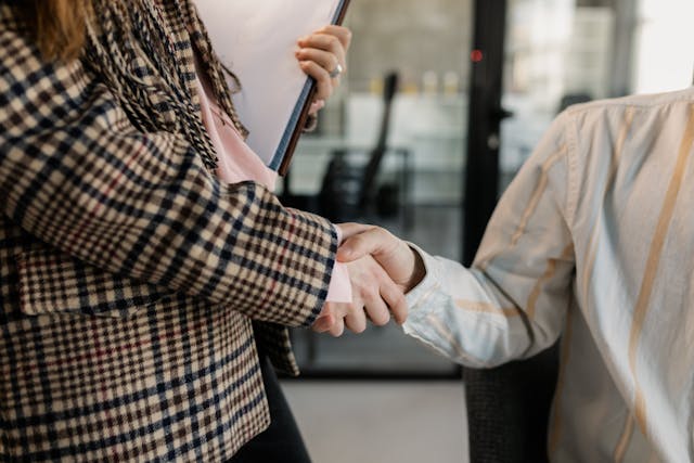 people-shaking-hands-with-documents