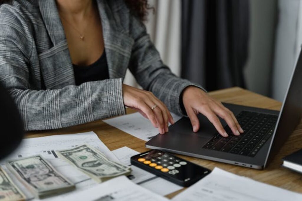 woman-working-on-laptop-with-papers