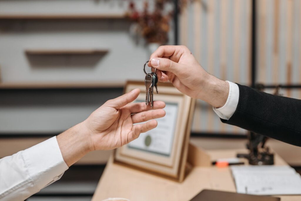 one person handing keys to another