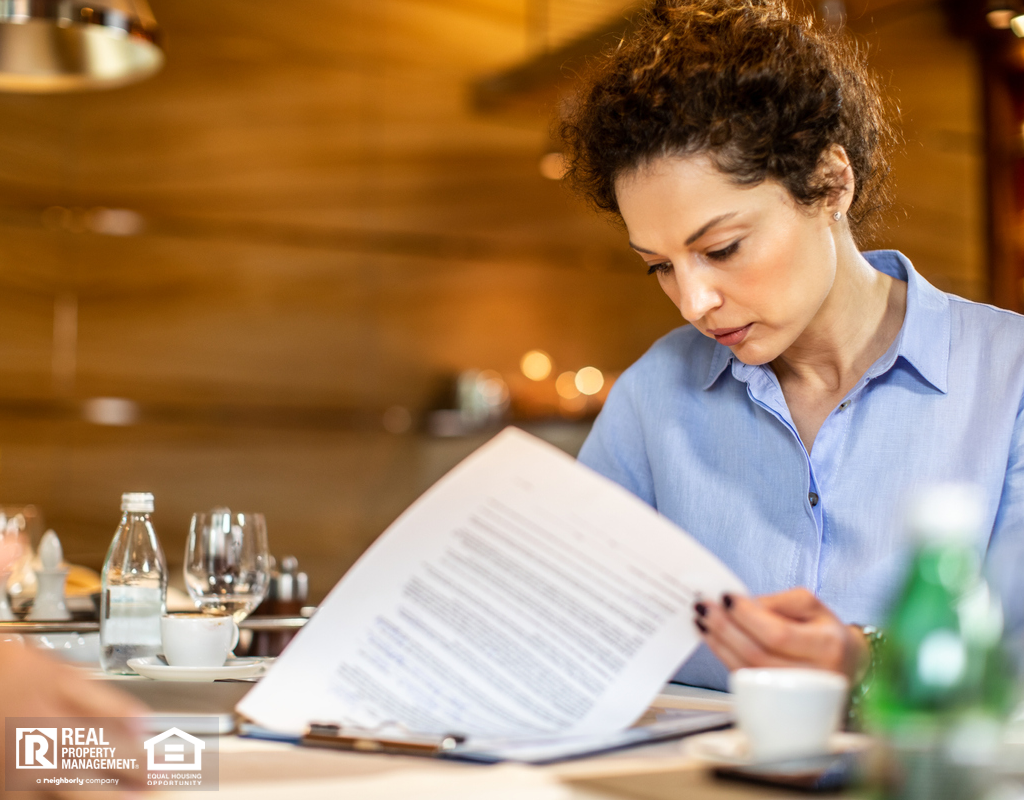 Young Entrepreneur Looking Over Paperwork Before Purchasing Property