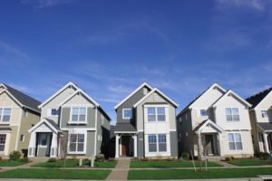 Street view of three gray houses