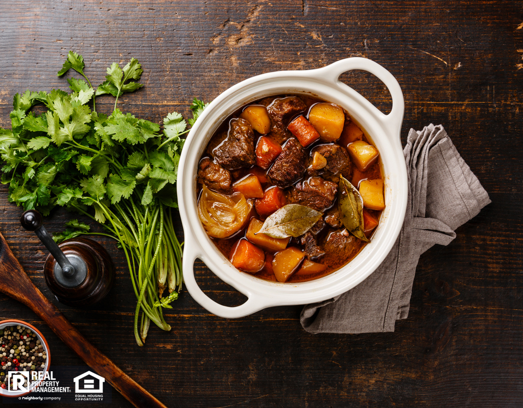 Aerial View of Beef Stew Next to Parsley, Salt, and Pepper