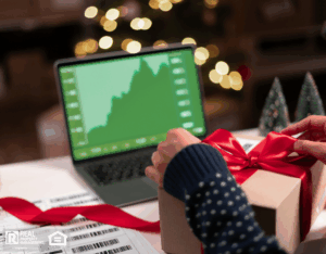 Real estate professional at their desk working on a laptop showing statistics, graphs during the holiday season.