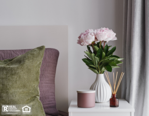 Fresh flowers and incense on a table near the window