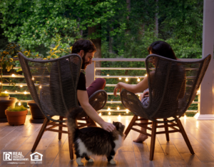 Couple Sitting on Outdoor Patio with String Lights