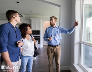 Male real estate agent shows new home