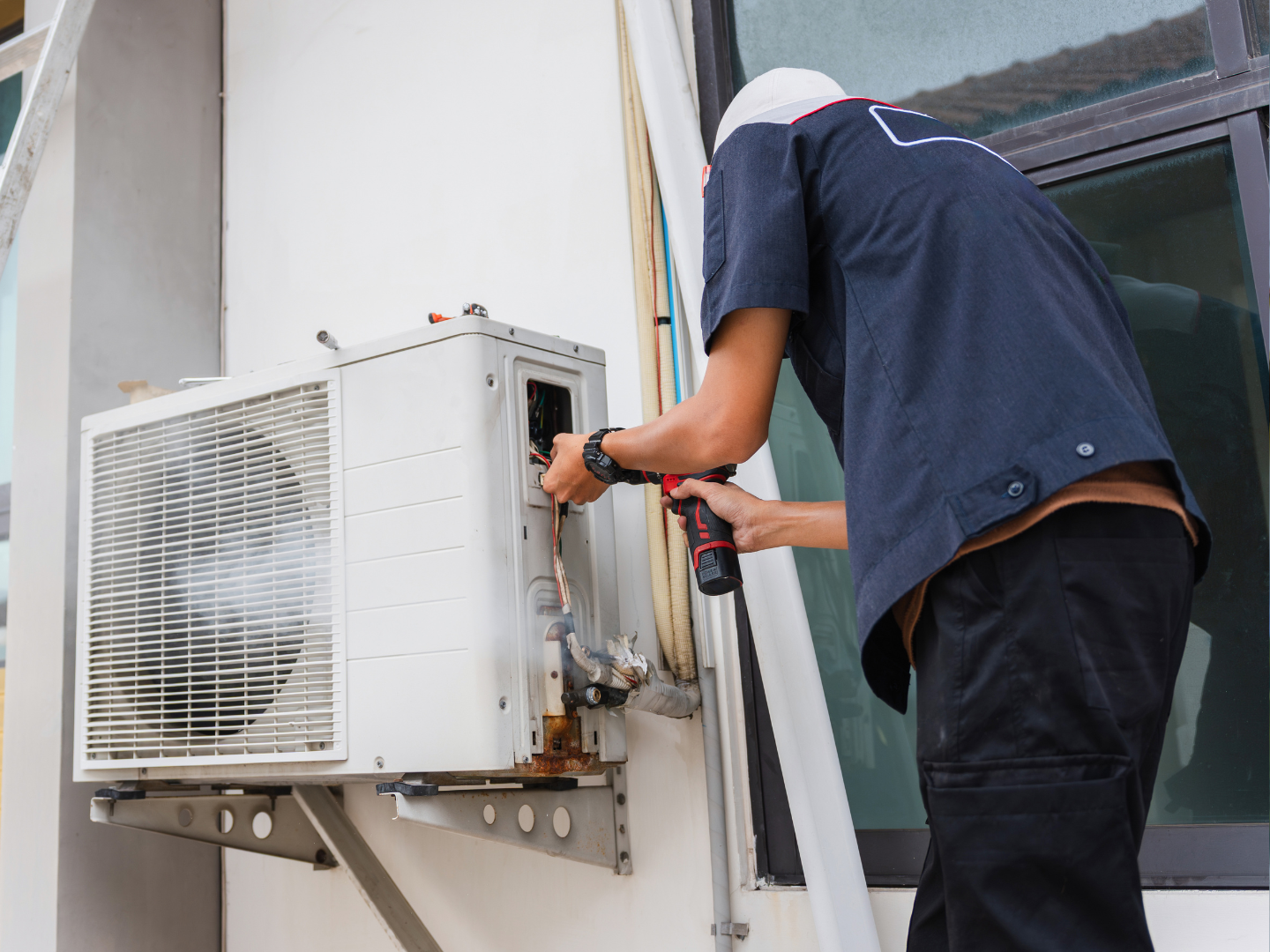 Maintenance technician servicing an air-conditioning system