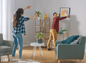 A Couple Hanging Photos on the Wall of Their Newburgh Rental Home